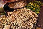 The market of Makale - stalls selling local produce including coffee, tobacco, buckets of live eels, piles of fresh and dried fish, and jugs of  'balok'