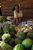 The market of Makale - stalls selling local produce including coffee, tobacco, buckets of live eels, piles of fresh and dried fish, and jugs of  'balok'