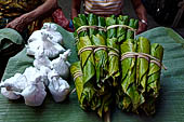 The market of Makale - stalls selling local produce including coffee, tobacco, buckets of live eels, piles of fresh and dried fish, and jugs of  'balok'