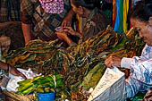 The market of Makale - stalls selling local produce including coffee, tobacco, buckets of live eels, piles of fresh and dried fish, and jugs of  'balok'