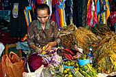 The market of Makale - stalls selling local produce including coffee, tobacco, buckets of live eels, piles of fresh and dried fish, and jugs of  'balok'