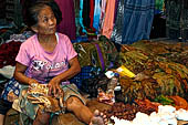 The market of Makale - stalls selling local produce including coffee, tobacco, buckets of live eels, piles of fresh and dried fish, and jugs of  'balok'