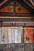 Pallawa - Traditional tongkonan house. The exterior walls are covered with wood panels etched with geometric patterns and painted with black and red colours. 